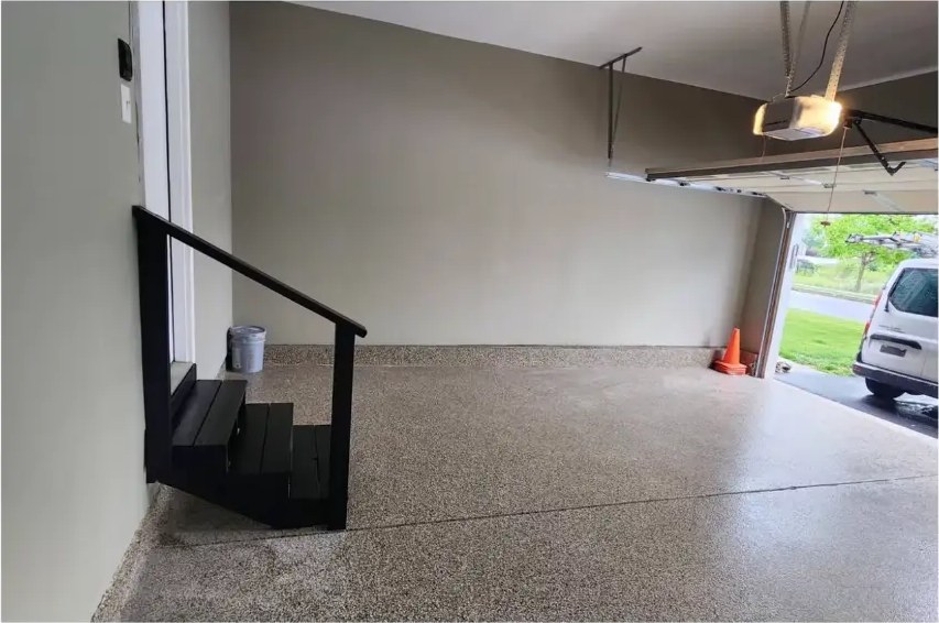 After: matte-black garage stairs and handrail with painted walls